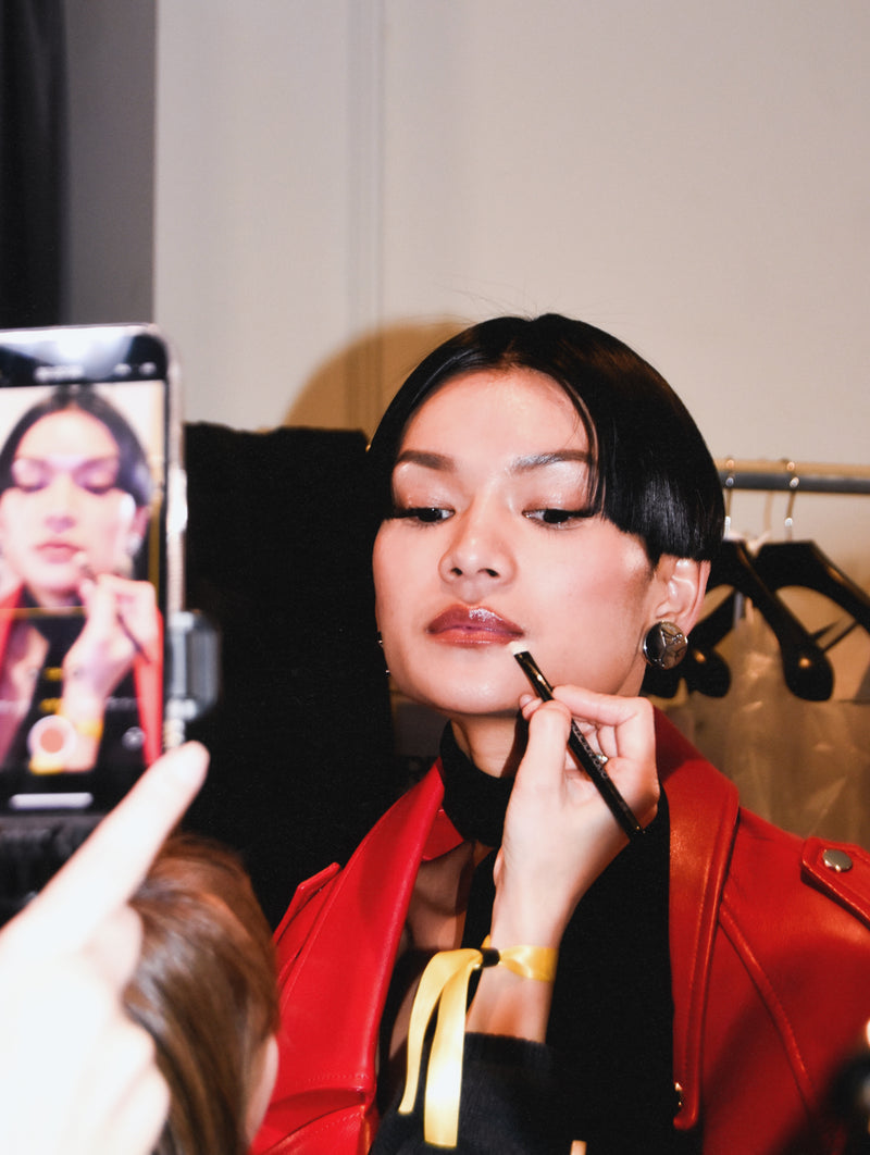 ADDICTION TOKYO x Retrofête model with lip product being applied